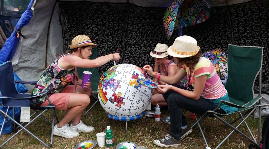 Ladies painting a piece of a globe